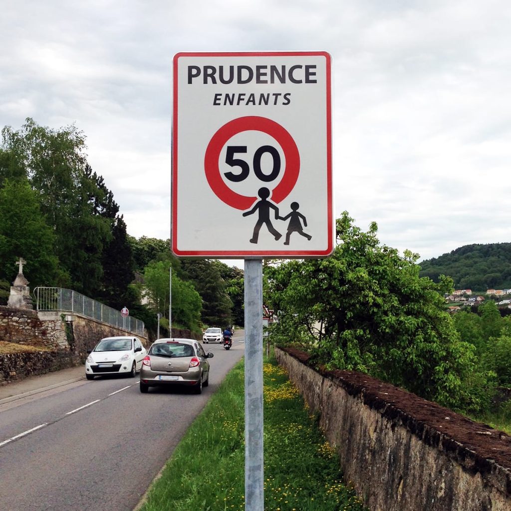 Panneau de signalisation 'Prudence Enfants' dans une rue aux abords d'une école